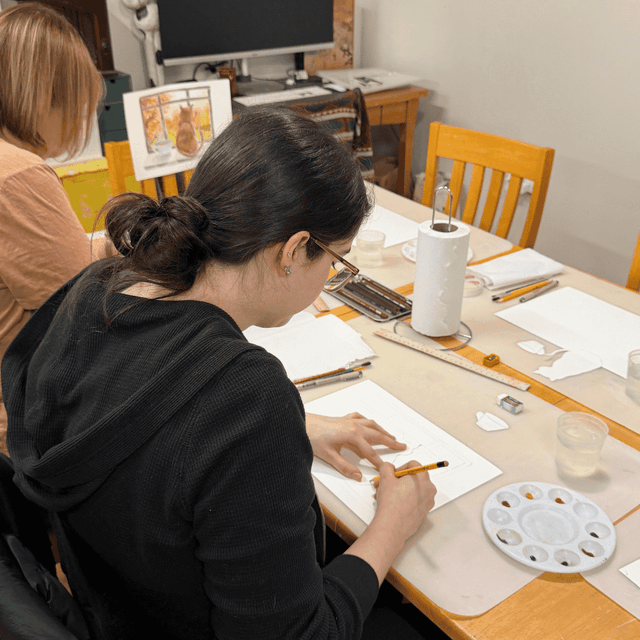 Volunteer drawing and creating art at Happy Hands Studio